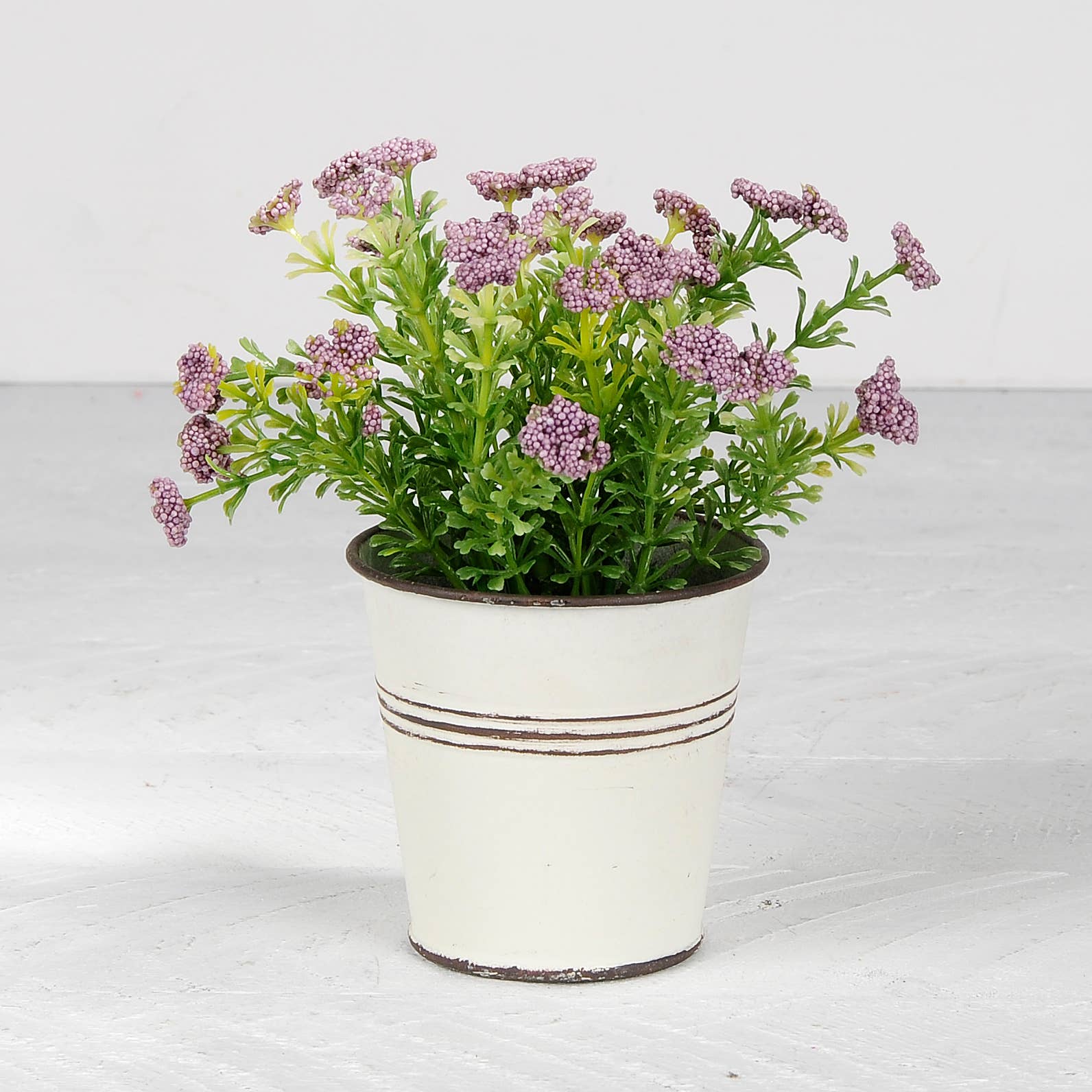 Purple Flowers In White Metal Pot