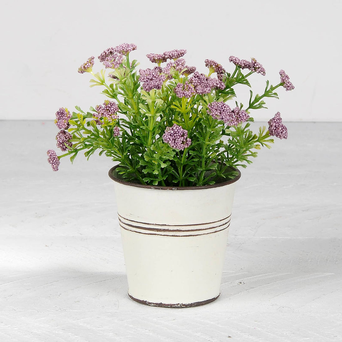 Purple Flowers In White Metal Pot